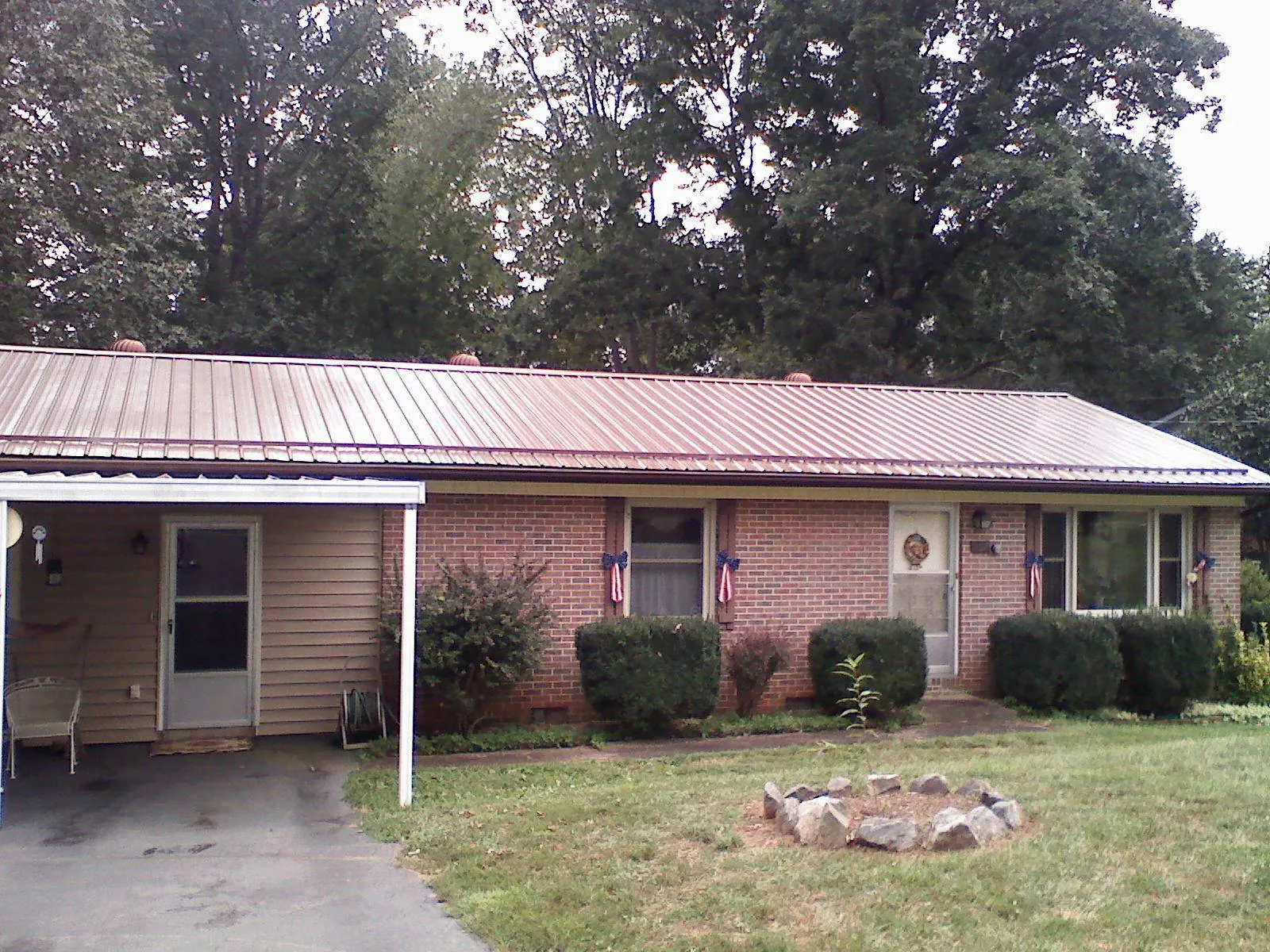 Bronze metal roof and carport on a brick ranch home — Roof Repair work by our crew in Richeyville