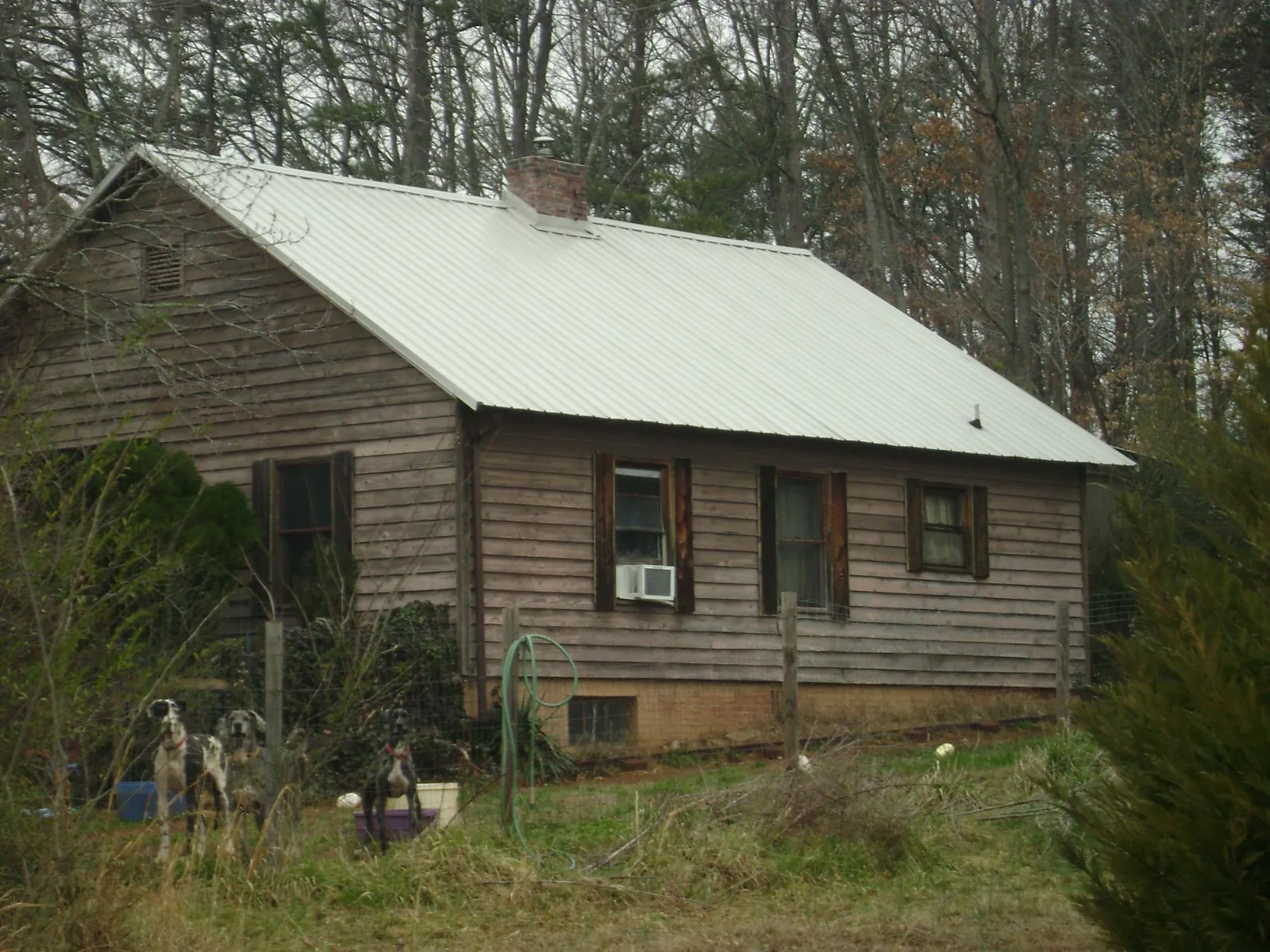 White metal roof on an old wood sided farmhouse, from a Metal Roof Installation job in Richeyville
